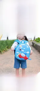 Close-up of lightweight blue hardshell backpack with a 3D red airplane design for kids