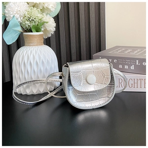 Close-up of silver crocodile texture mini crossbody bag with white snap button closure