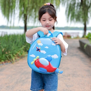 Light blue 3D cartoon airplane hardshell backpack for toddlers in a scenic park outdoor