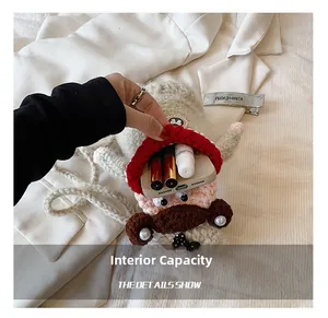 Detailed interior of the hand-knitted crossbody bag showing capacity for phone and lipstick