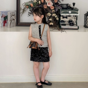 Fashionable girls' brown bucket bag paired with a tweed vest and sequin skirt outfit