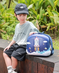 Outdoor shot of a 3D space rocket hard shell backpack for kids with an astronaut theme