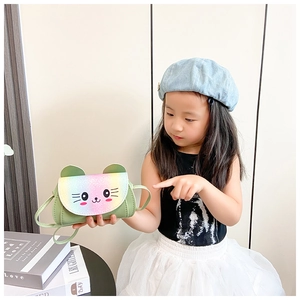 Girl wearing a mint green crossbody bag with rainbow sequin cat ears and kitten face