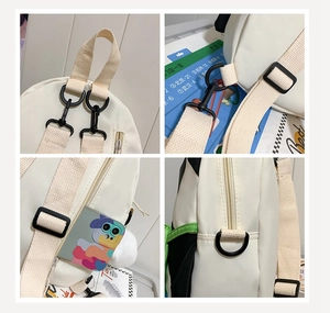 Detail showing white nylon backpack hardware, adjustable straps, and zipper compartment