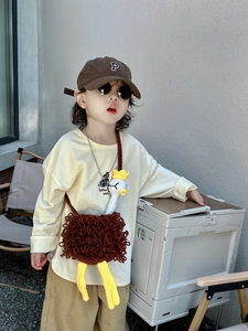 Detail of handmade crochet ostrich crossbody bag for kids with fuzzy brown knit texture