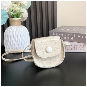 Detail of cream mini faux crocodile PU leather saddle bag with white round buckle