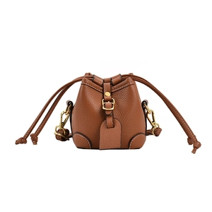 Brown litchi grain leather mini bucket bag with drawstring closure and metal buckle
