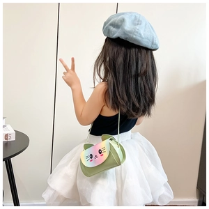 Rear view of a young girl wearing the colorful kitten rainbow crossbody bag at home