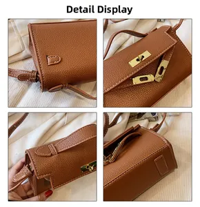 Close-up of brown litchi pattern leather texture with golden hardware and white stitching