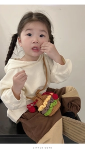 Toddler model wearing a handmade crochet hamburger drawstring mini crossbody bag