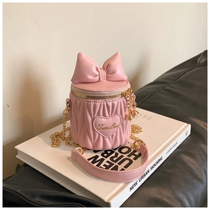 Detail of pink quilted bucket bag with bow, gold chain, and True Love lettering