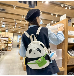 Detail shot of cute panda canvas backpack with mini green pocket and wide shoulder straps