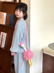 Handmade crochet pink ostrich crossbody bag for kids shown in use by child model