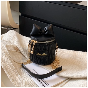 Detailed view of black bucket bag featuring bow decor and TrueLove heart embroidery