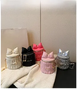 Group shot of mini bucket bags in five colors with bow detail and heart patches