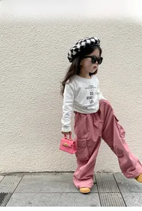 Fashionable girls' white long-sleeve tee with pink cargo pants and stylish beret