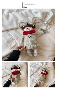 Detail view of handmade beige crochet doll bag with red scarf and pearl accents