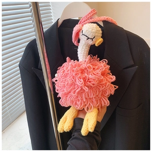 Detail of handmade crochet pink ostrich bag featuring plush texture and creative design