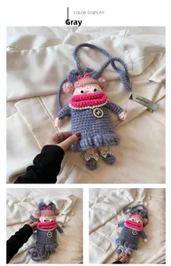 Detail of grey handmade crochet doll bag with pink sausage lips and pearl necklace