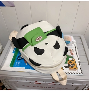 Close-up of cute panda backpack featuring green pocket detail and 3D decorative ears