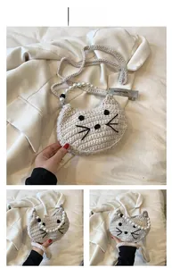 Detail of crochet cat-shaped bag with pearl handle and embroidered whiskers in beige
