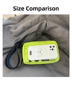 Comparaison de taille montrant le sac bandoulière vert néon à côté d'un téléphone