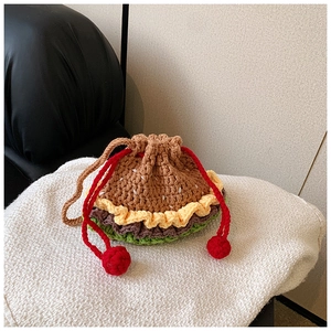 Macro shot of detailed crochet layers and drawstring on the burger shaped knit bag