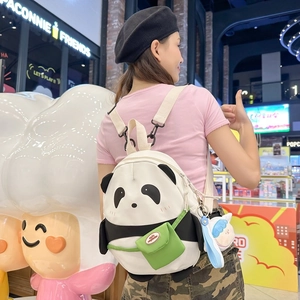 Cute panda cartoon mini backpack with adjustable straps worn by model in a stylish shop