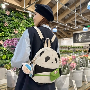Cute panda cartoon backpack with mini green pocket and doll charm for daily casual use