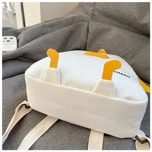 Detail view of white canvas backpack featuring cute yellow duck feet and CHASO print