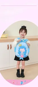 Close-up of blue mermaid backpack for kids with vibrant shell print and crown detail