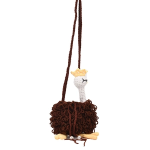 Handmade crochet ostrich crossbody bag with a fuzzy brown texture and yellow crown