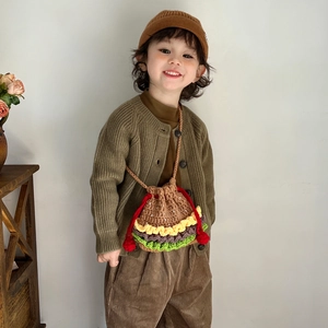 Cute hamburger crochet bucket bag with red drawstring strap shown on a young child