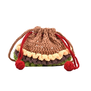 Handmade crochet hamburger drawstring bucket bag with colorful knitted layers and red pom-poms