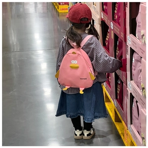 Pink cartoon duck backpack for children showing the back-worn size and fit on a young girl