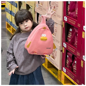 Pink duck canvas backpack for kids shown on model to demonstrate size and fit