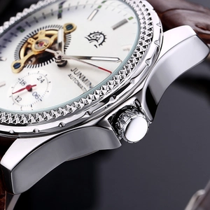 Close-up of polished steel bezel and crown on automatic mechanical men's watch
