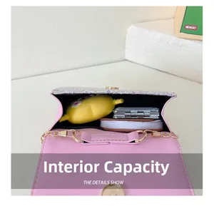 Internal storage view of pink bow girl's crossbody bag with small toys and stationery
