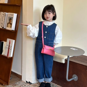 Fashionable girls pink crossbody bag with litchi pattern shown with a denim outfit