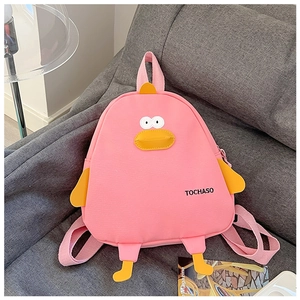 Detail of pink canvas cartoon chick backpack with 3D yellow beak and wings on grey sofa