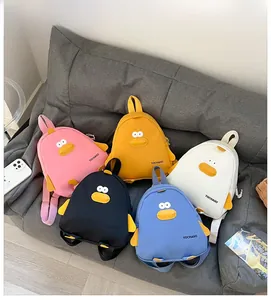 Detailed flat lay of cute cartoon duck canvas backpacks in five vibrant colors for kids