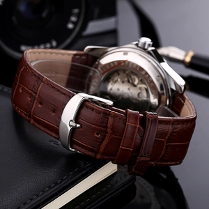 Business mechanical watch with brown leather strap and stainless steel see-through back