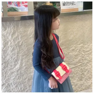 Détail du sac bandoulière enfant multicolore avec bandoulière rouge et boucles roses