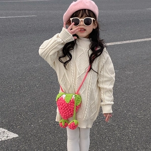 Detail of handmade knit strawberry crossbody bag for girls with 3D woven texture