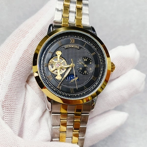 Detail of Junming automatic mechanical watch with skeleton dial and two-tone steel band