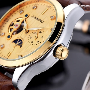 Macro detail of men's automatic watch showing tourbillon window and textured dial