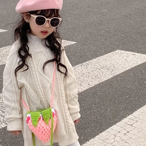 Cute pink strawberry crochet shoulder bag for children with white dots and green leaves