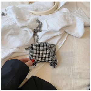 Detail of mini sparkling rhinestone crossbody bag with thick silver metal chain strap