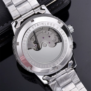 Macro view of mechanical watch movement through transparent stainless steel back