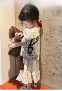 Close-up of sparkling rhinestone moon bag for girls with chain strap on child model
